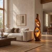 Floor lamp shaped as a twisting vase with open ribbon cutouts that glow in a bright open plan living room