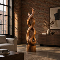 Twisted wood sculpture of intertwined ribbons on a short cylinder base in an industrial loft living room with exposed brick