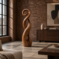 Twisted ribbon sculpture with open loops, a spiral top and a dark base in an industrial loft living room with exposed brick