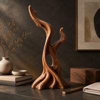 Corner detail of twisted root style sculpture with an open hollow and two flame shaped tips beside wood, brass and linen samples