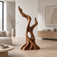 Twisted root style sculpture with an open hollow and two flame shaped tips in a Scandinavian living room with white walls