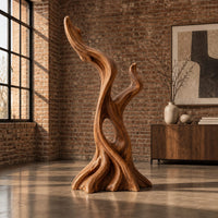 Twisted root style sculpture with an open hollow and two flame shaped tips in an industrial loft living room with exposed brick