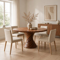 Circular dining table with a twisted spiral hourglass pedestal in a Scandinavian dining room with white walls