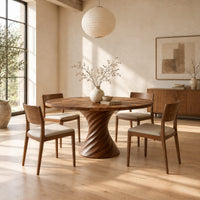 Circular dining table with a twisted spiral hourglass pedestal in a bright open plan dining room