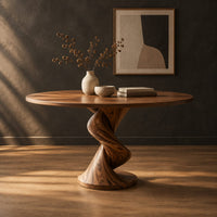 Round dining table with a twisting spiral pedestal on a circular foot in a dark studio against a charcoal plaster wall