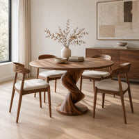 Round dining table with a twisting spiral pedestal on a circular foot in a Scandinavian dining room with white walls