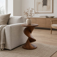 Round side table with a twisting spiral pedestal and a flared base in a Scandinavian living room with white walls