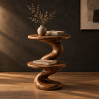 Side table with a spiral twisted stem and two round tiers in a dark studio against a charcoal plaster wall