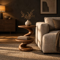 Side table with a spiral twisted stem and two round tiers in a dark living room at golden hour