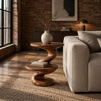 Side table with a spiral twisted stem and two round tiers in an industrial loft living room with exposed brick