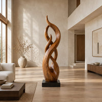 Twisting flame shaped sculpture with braided open loops on a square block base in a bright open plan living room