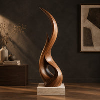 Tall twisting flame shaped wood sculpture with an open loop near the base, three-quarter view showing the grain