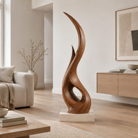Tall twisting flame shaped wood sculpture with an open loop near the base in a Scandinavian living room with white walls