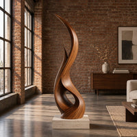 Tall twisting flame shaped wood sculpture with an open loop near the base in an industrial loft living room with exposed brick
