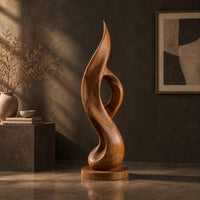Tall twisting flame sculpture with an open loop on a flat disc base, three-quarter view showing the grain