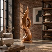 Tall twisting flame sculpture with an open loop on a flat disc base in an industrial loft living room with exposed brick