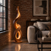 Twisting ribbon floor lamp with warm glow inside its loops in an industrial loft living room with exposed brick