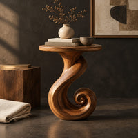 Corner detail of round side table on a ribbon pedestal that ends in a spiral curl beside wood, brass and linen samples