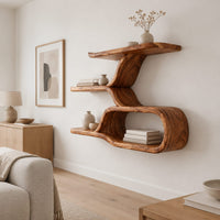 Wall shelf with a twisting trunk and an open oval loop below in a Scandinavian living room with white walls
