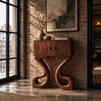 Two door console cabinet on large looping ribbon shaped legs in an industrial loft entryway with exposed brick