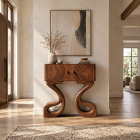 Two door console cabinet on large looping ribbon shaped legs in a bright open plan entryway
