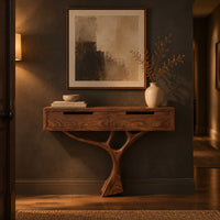 Console table with a two drawer box on a single branching tree pedestal in a dark entryway at golden hour