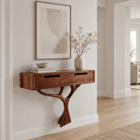 Console table with a two drawer box on a single branching tree pedestal in a Scandinavian entryway with white walls