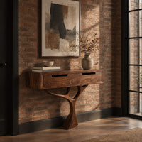 Console table with a two drawer box on a single branching tree pedestal in an industrial loft entryway with exposed brick