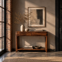 Console table with a two panel front rail and a low open shelf in an industrial loft entryway with exposed brick