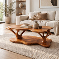 Two tier coffee table with a freeform top and branch shaped supports in a Scandinavian living room with white walls