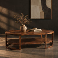 Two tier oval wooden coffee table with slim legs and half ring supports, three-quarter view showing the grain