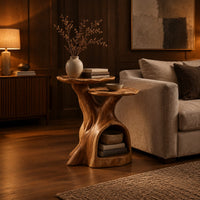 Two tier side table with a trunk base and a hollow for books in an evening living room with walnut wall paneling