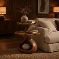 Two tier side table with scalloped tops and a twisting stem in an evening living room with walnut wall paneling
