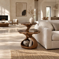 Two tier side table with scalloped tops and a twisting stem in a bright open plan living room