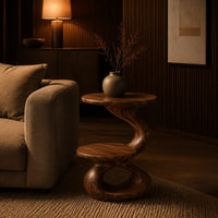 Two tier side table with a twisted stem and a figure eight base in an evening living room with walnut wall paneling