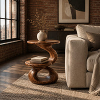 Two tier side table with a twisted stem and a figure eight base in an industrial loft living room with exposed brick