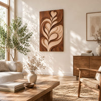 Wall art panel with a carved leaf relief in light and dark tones in a bright sunroom with green plants