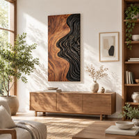 Tall wall art panel split between natural wood grain and black carved ripples in a bright sunroom with green plants
