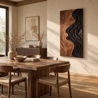 Tall wall art panel split between natural wood grain and black carved ripples beside a dining table in natural light