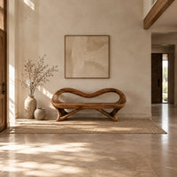 Wooden bench with a wavy looped rim and slender splayed legs in a bright open plan entryway