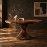 Round dining table on a twisted pedestal with a flared disc base, three-quarter view showing the grain