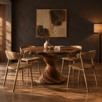 Round dining table on a twisted pedestal with a flared disc base in a dark dining room at golden hour