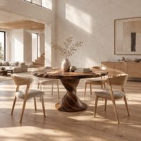 Round dining table on a twisted pedestal with a flared disc base in a bright open plan dining room