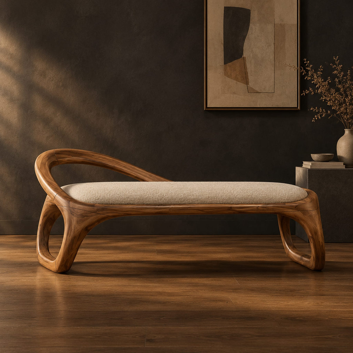 Bench with a padded seat and an arched back rail on open loop legs in a dark studio against a charcoal plaster wall