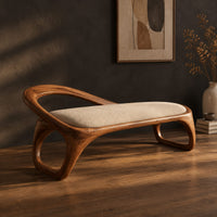 Bench with a padded seat and an arched back rail on open loop legs, three-quarter view showing the grain