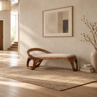 Bench with a padded seat and an arched back rail on open loop legs in a bright open plan entryway