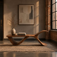 Bench with a flat plank seat, a swooping base and an upswept tail in an industrial loft entryway with exposed brick