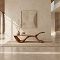 Bench with a flat plank seat, a swooping base and an upswept tail in a bright open plan entryway