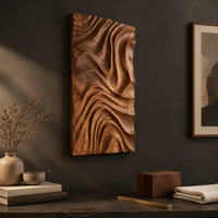 Detail of tall wooden wall art panel carved with deep swirling ripple ridges beside wood, brass and linen samples