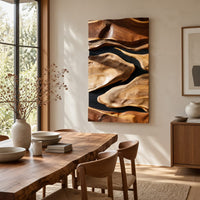 Vertical carved wall art with flowing forms on a dark ground beside a dining table in natural light